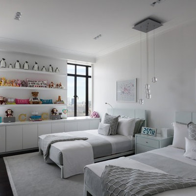 Trendy gender-neutral dark wood floor kids' room photo in New York with white walls