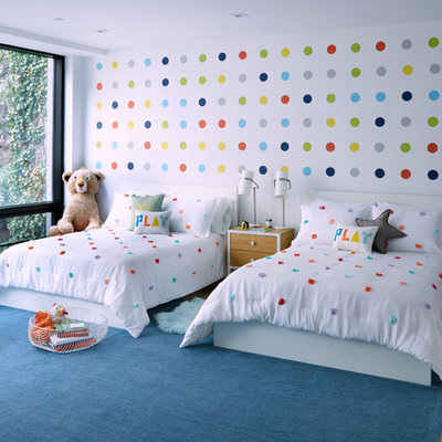 Example of a mid-sized trendy gender-neutral light wood floor and beige floor kids' room design in Other with white walls