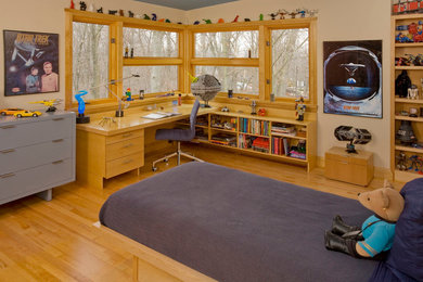 Contemporary kids' bedroom for boys in Chicago with beige walls and medium hardwood flooring.