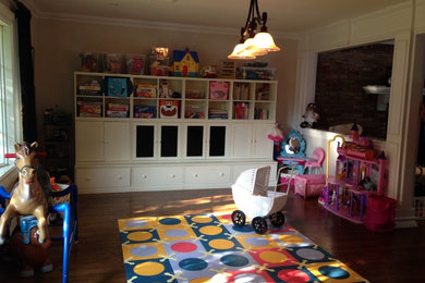 Large elegant gender-neutral dark wood floor and brown floor kids' room photo in New York with beige walls