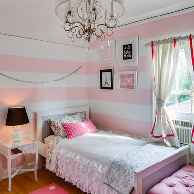 Transitional girl medium tone wood floor kids' bedroom photo in Chicago with multicolored walls