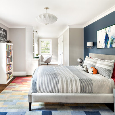 Transitional boy dark wood floor and brown floor kids' room photo in New York with blue walls