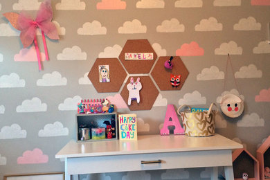 This is an example of a medium sized modern children’s room for girls in San Francisco with grey walls.