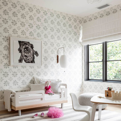 Mid-sized transitional girl light wood floor and brown floor kids' room photo in Dallas with multicolored walls