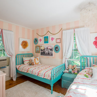 Example of a mid-sized classic girl medium tone wood floor kids' room design in Boston with multicolored walls