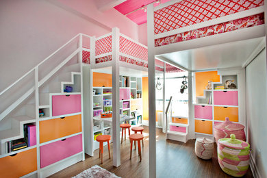 Inspiration for a mid-sized eclectic girl medium tone wood floor kids' room remodel in New York with white walls