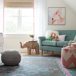 Large girl light wood floor kids' room photo in Boston with white walls