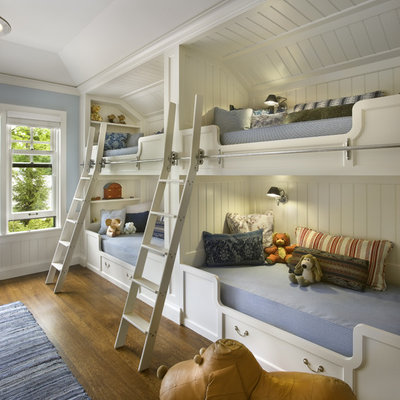 Elegant gender-neutral medium tone wood floor kids' room photo in Chicago with blue walls