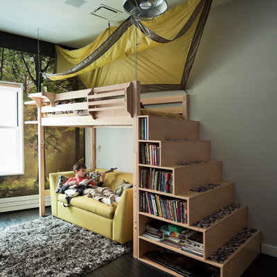 Trendy boy dark wood floor kids' room photo in New York with gray walls