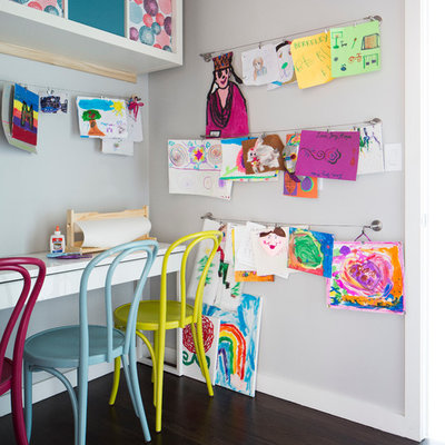 Example of a mid-sized trendy gender-neutral dark wood floor kids' room design in Dallas with gray walls