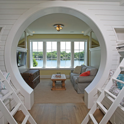 Example of a mid-sized beach style gender-neutral light wood floor and brown floor kids' room design in Minneapolis with yellow walls