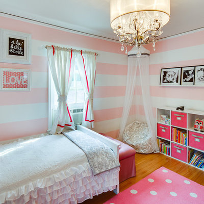 Example of a trendy girl medium tone wood floor kids' room design in Minneapolis with multicolored walls