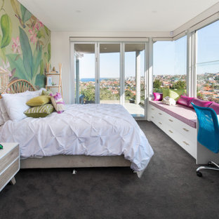 This is an example of a contemporary kids' room for girls in Sydney with carpet, grey floor and multi-coloured walls.