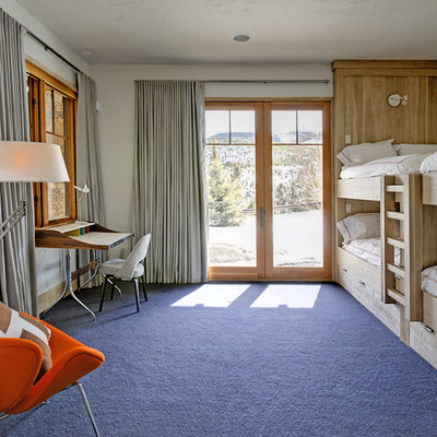 Example of an eclectic gender-neutral carpeted and blue floor kids' room design in New York
