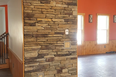 Engineered stone veneer accent wall, fireplace, and column