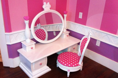 Inspiration for a mid-sized timeless girl dark wood floor and brown floor kids' room remodel with pink walls