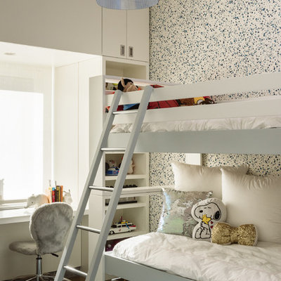 Trendy medium tone wood floor and brown floor kids' bedroom photo in New York with white walls