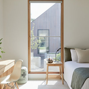 Photo of a scandinavian gender-neutral kids' room in Melbourne with white walls, carpet and beige floor.