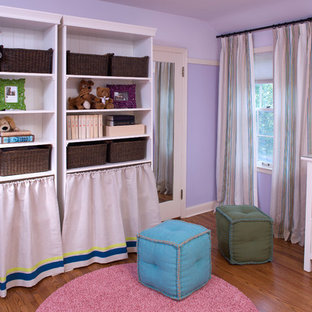 Kids' room - contemporary girl medium tone wood floor kids' room idea in Minneapolis with purple walls