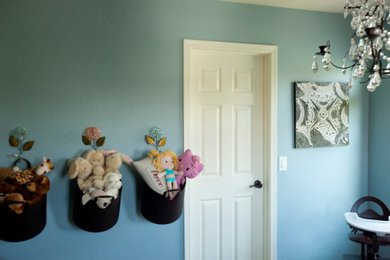 Photo of a medium sized traditional children’s room for girls in Orange County with blue walls and carpet.