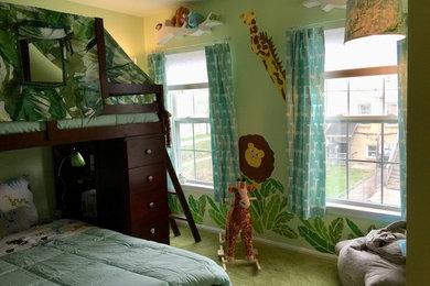 Photo of a small eclectic toddler’s room for boys in Baltimore with green walls, carpet and green floors.