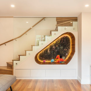 Inspiration for a modern gender-neutral kids' playroom in Sydney with white walls, medium hardwood floors and brown floor.