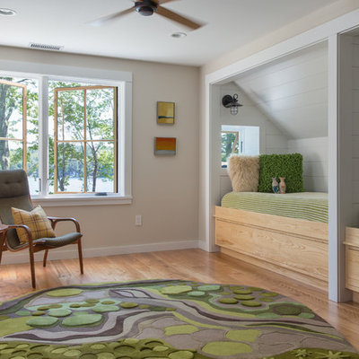 Inspiration for a mid-sized transitional gender-neutral light wood floor and brown floor kids' room remodel in Portland Maine with beige walls