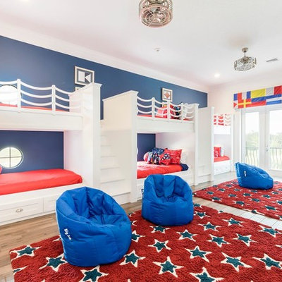 Example of a beach style gender-neutral light wood floor kids' room design in Orlando with white walls
