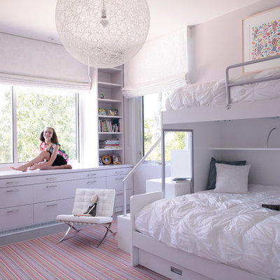 Mid-sized trendy girl painted wood floor kids' room photo in New York with gray walls