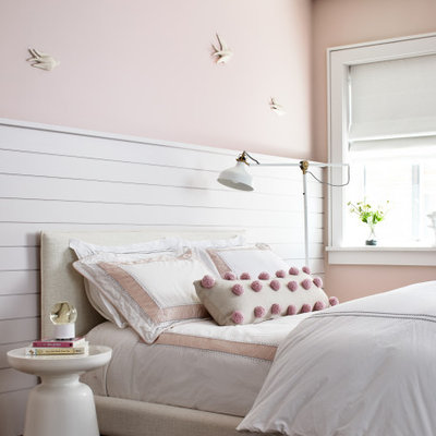 Example of a large transitional girl medium tone wood floor and brown floor kids' room design in Los Angeles with pink walls