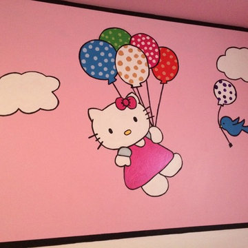 Hello Kitty holding onto balloons with her bird friend