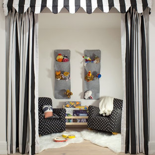 Inspiration for a scandinavian gender-neutral light wood floor kids' room remodel in Denver with white walls