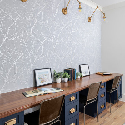 Mid-sized transitional gender-neutral light wood floor kids' room photo in Charlotte with multicolored walls