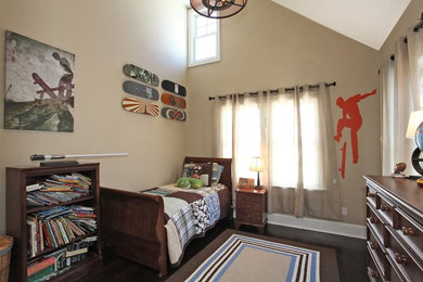 This is an example of a medium sized contemporary teen’s room for boys in New York with beige walls, dark hardwood flooring and brown floors.