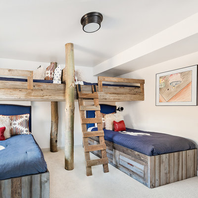 Mid-sized mountain style gender-neutral dark wood floor and brown floor kids' bedroom photo in Other with white walls