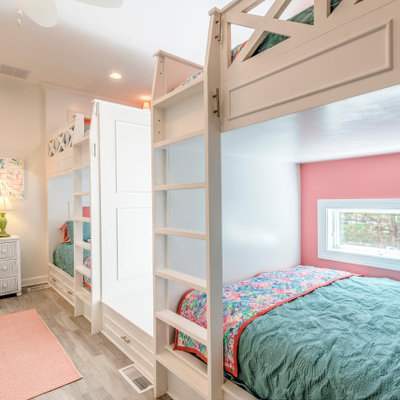 Kids' room - large coastal girl light wood floor and gray floor kids' room idea in Other with pink walls