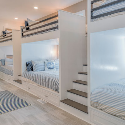 Inspiration for a large coastal boy light wood floor kids' room remodel in Other with white walls
