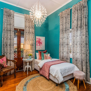 Inspiration for a transitional kids' bedroom for kids 4-10 years old and girls in Brisbane with green walls, medium hardwood floors and brown floor.