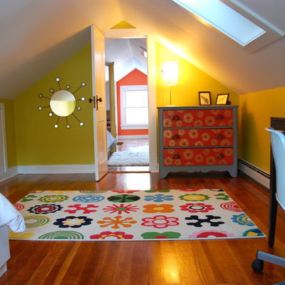 Example of an eclectic gender-neutral medium tone wood floor kids' study room design in New York with yellow walls