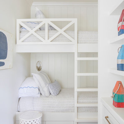 Beach style gender-neutral dark wood floor and brown floor kids' bedroom photo in Charleston with white walls