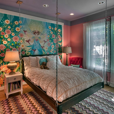 Example of a transitional girl medium tone wood floor kids' room design in Seattle with multicolored walls