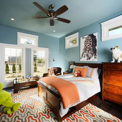 Inspiration for a mid-sized timeless boy medium tone wood floor kids' room remodel in Other with blue walls