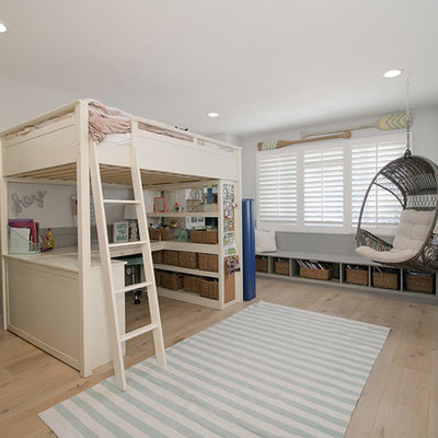 Large beach style girl light wood floor and brown floor kids' room photo in Orange County with white walls