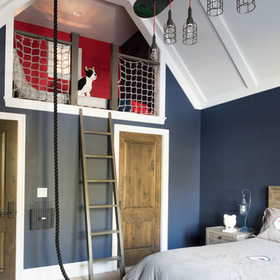 Example of a beach style light wood floor and beige floor kids' bedroom design in Minneapolis with blue walls