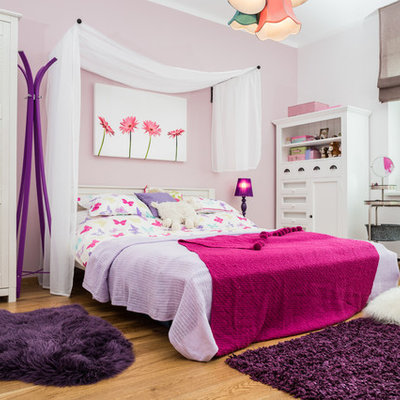 Elegant girl light wood floor kids' room photo in Other with multicolored walls