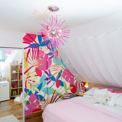 Eclectic girl medium tone wood floor kids' room photo in Other with white walls
