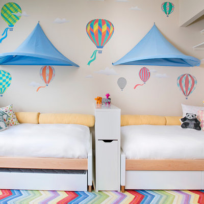 Inspiration for a mid-sized modern gender-neutral light wood floor kids' room remodel in New York with beige walls