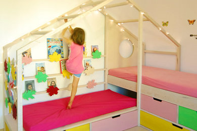 Example of a mid-sized trendy girl light wood floor and beige floor kids' room design in Other with yellow walls