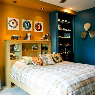 Inspiration for a mid-sized timeless boy carpeted kids' room remodel in Other with blue walls