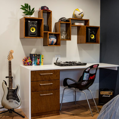Mid-sized trendy boy light wood floor and orange floor kids' room photo in Los Angeles with black walls